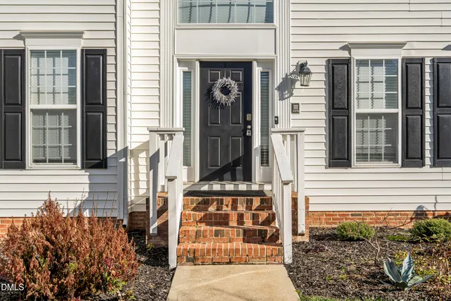 a view of staircase with white walls and a rug