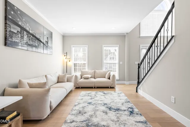 a living room with furniture and view of kitchen
