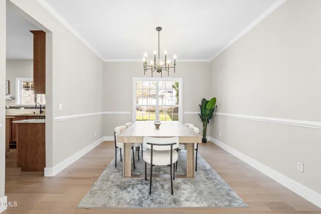 a living room with furniture and a dining table