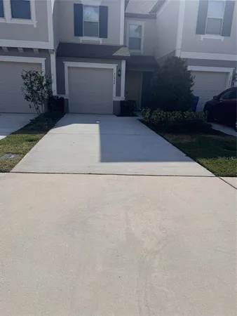 a front view of a house with a yard and a garden