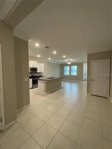 a kitchen with stainless steel appliances kitchen island granite countertop a refrigerator and a stove top oven