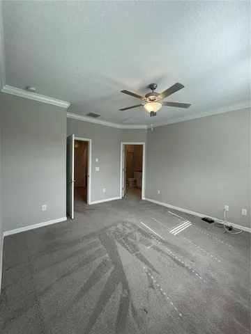 a view of an empty room with a ceiling fan
