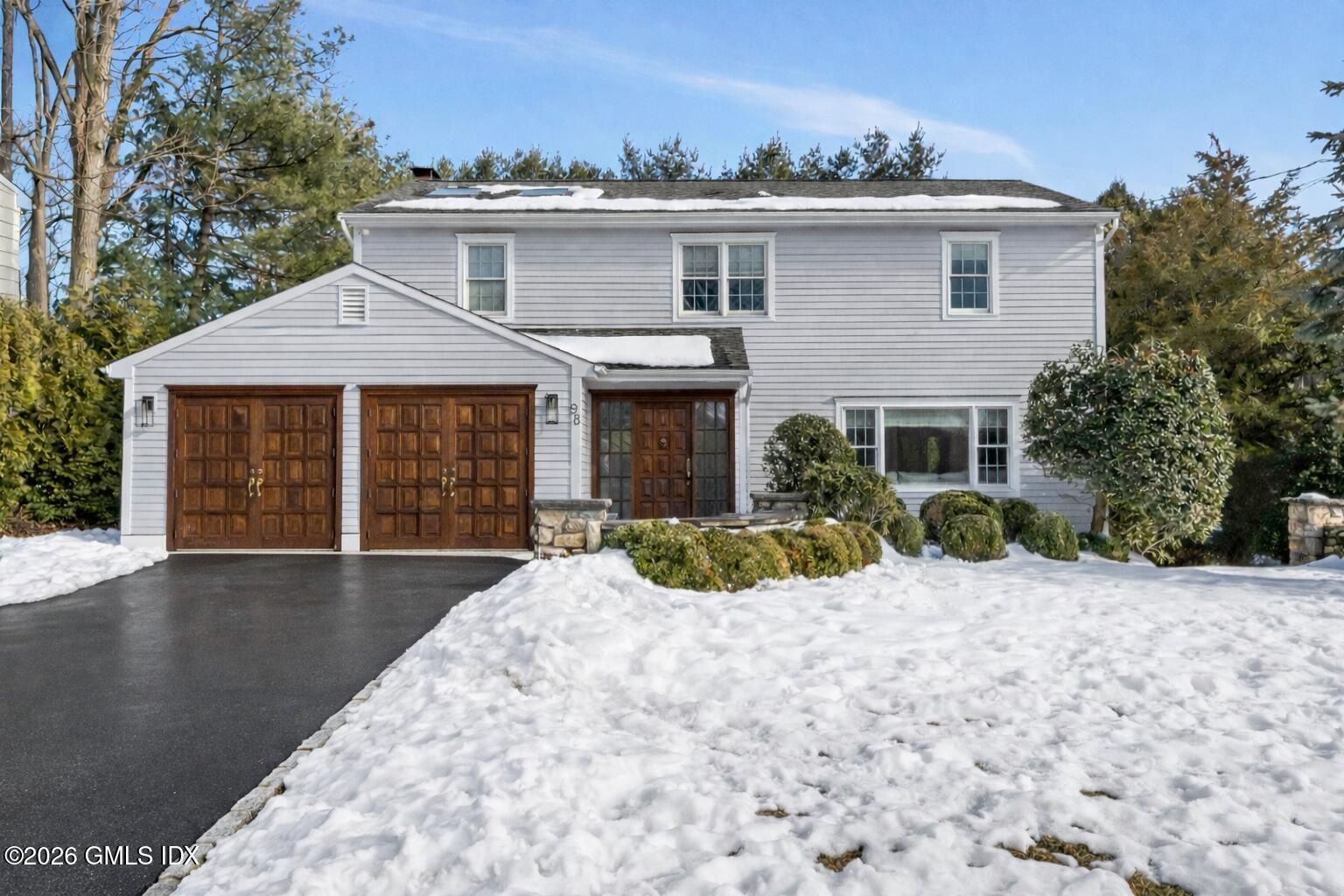 98 Hillcrest Park Road Cos Cob, CT 06807 - Photo 1 of 27 a front view of a house with a yard
