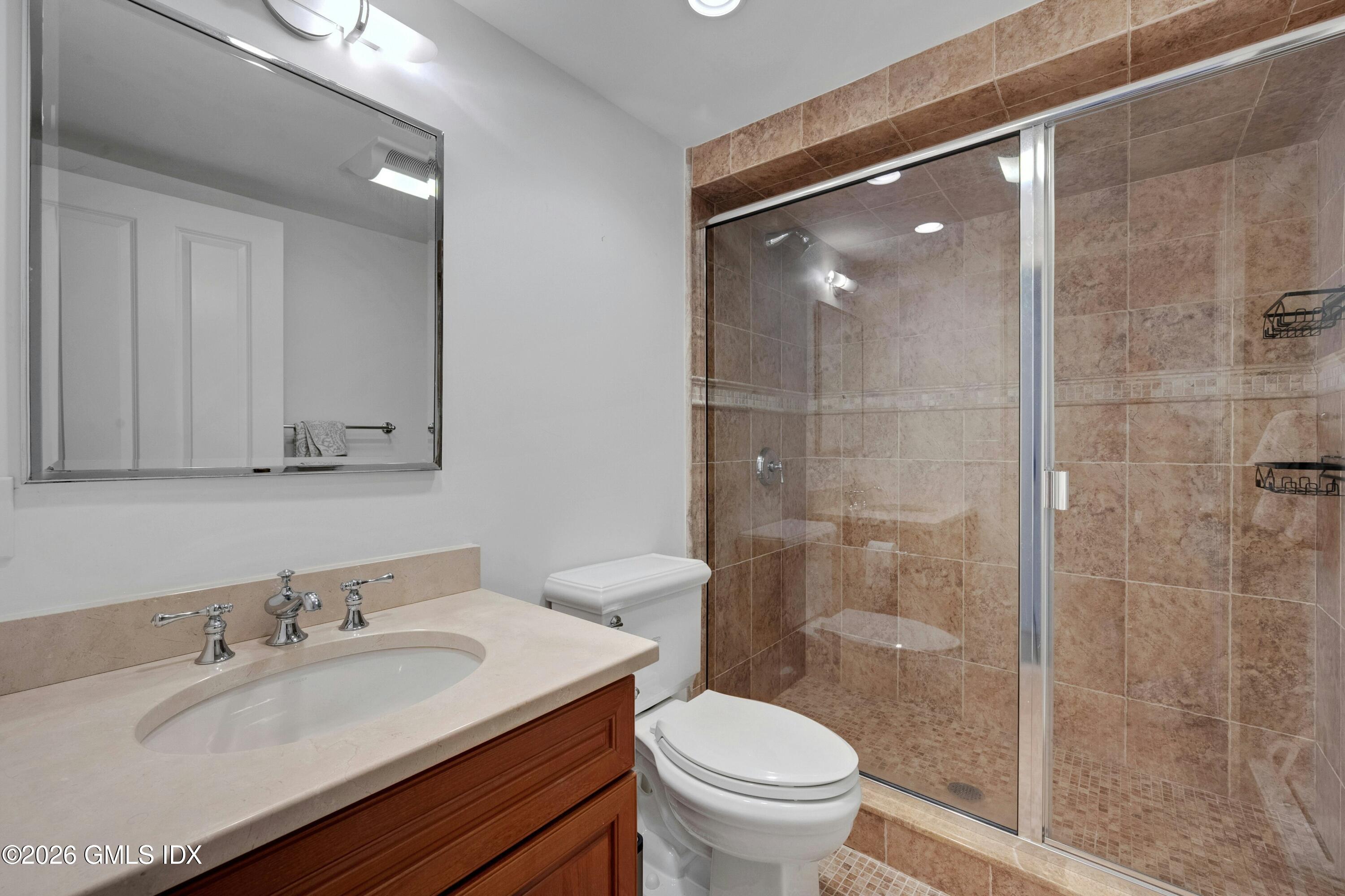 98 Hillcrest Park Road Cos Cob, CT 06807 - Photo 20 of 27 a bathroom with a granite countertop sink toilet and shower