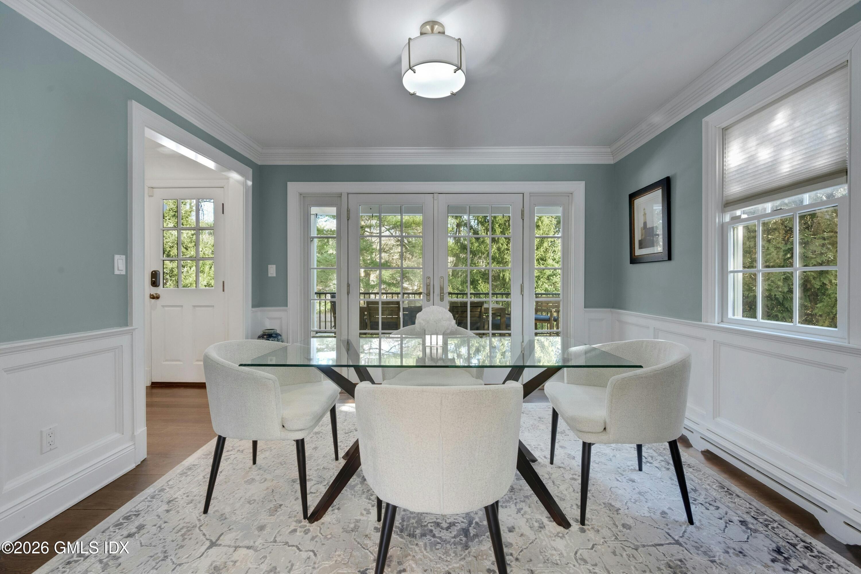 98 Hillcrest Park Road Cos Cob, CT 06807 - Photo 7 of 27 a dining room with furniture a chandelier and wooden floor