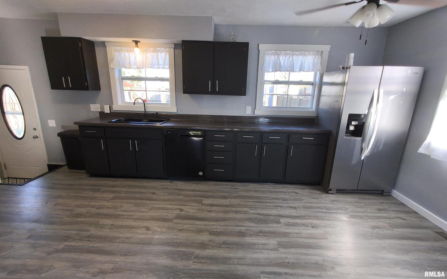 20 South Peach Street Du Quoin, IL 62832 - Photo 6 of 22 a kitchen with stainless steel appliances granite countertop a refrigerator a sink a stove a microwave a counter space and cabinets