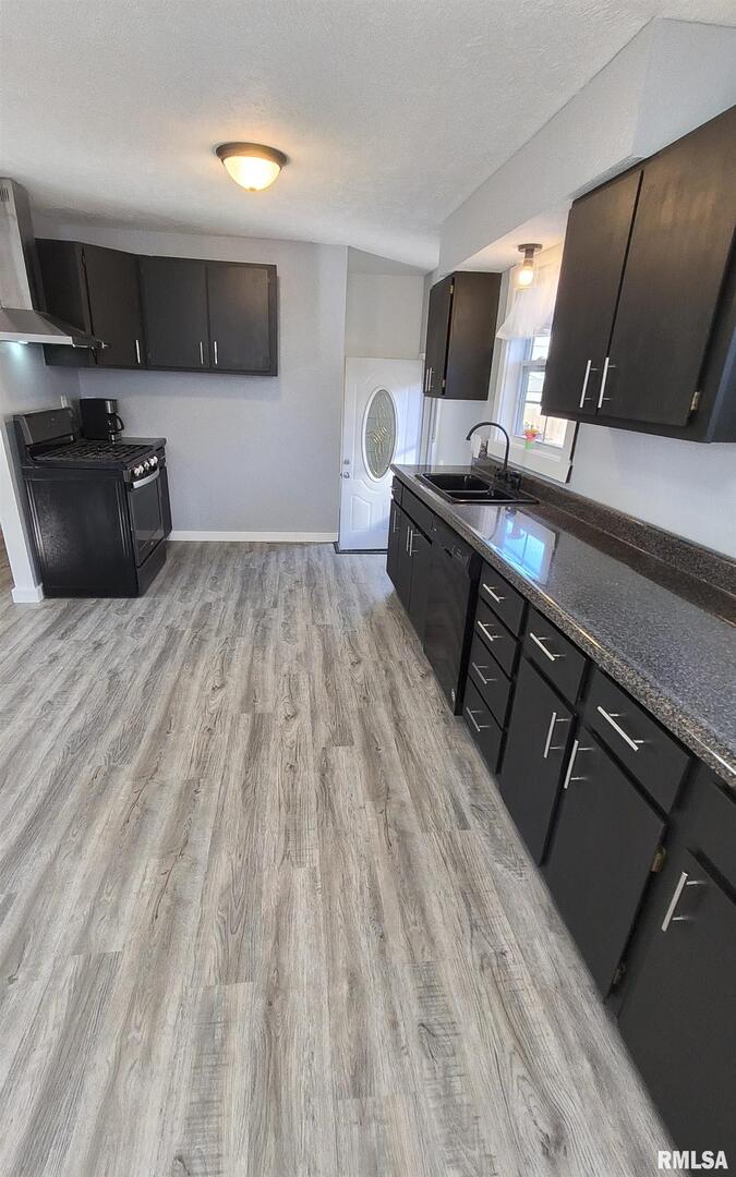 20 South Peach Street Du Quoin, IL 62832 - Photo 7 of 22 a kitchen with a sink and a stove top oven