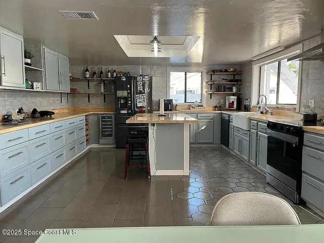 a kitchen with a stove a sink and a refrigerator