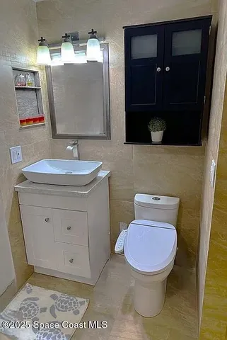 a bathroom with a toilet a sink and mirror