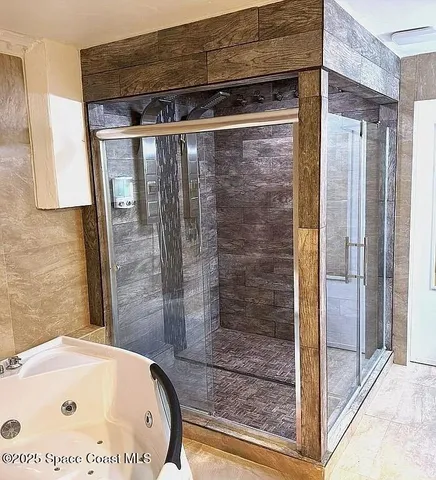 a bathroom with a tub and shower