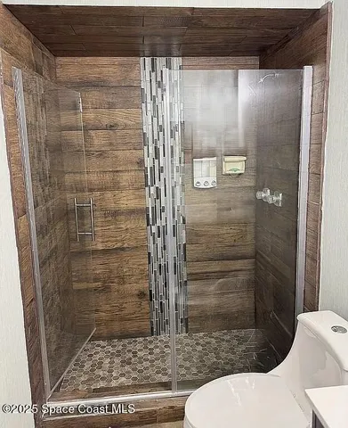 a bathroom with a shower and toilet