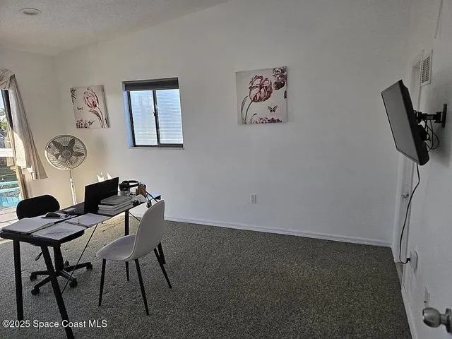 a view of a livingroom with furniture and window