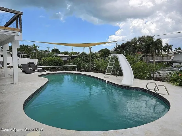 a view of a swimming pool with a patio