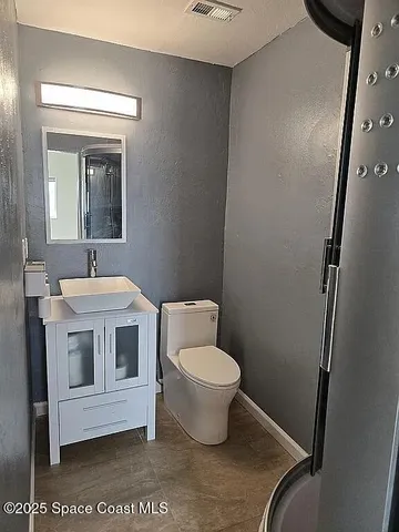 a view of a chairs and table in the balcony