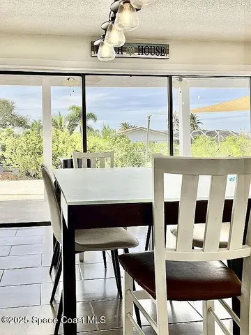 a view of a dining room with furniture and a window