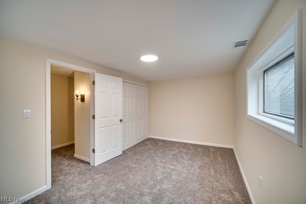 7060 Lear Nagle Road North Ridgeville, OH 44039 - Photo 24 of 29 Unfurnished bedroom featuring a closet and light colored carpet