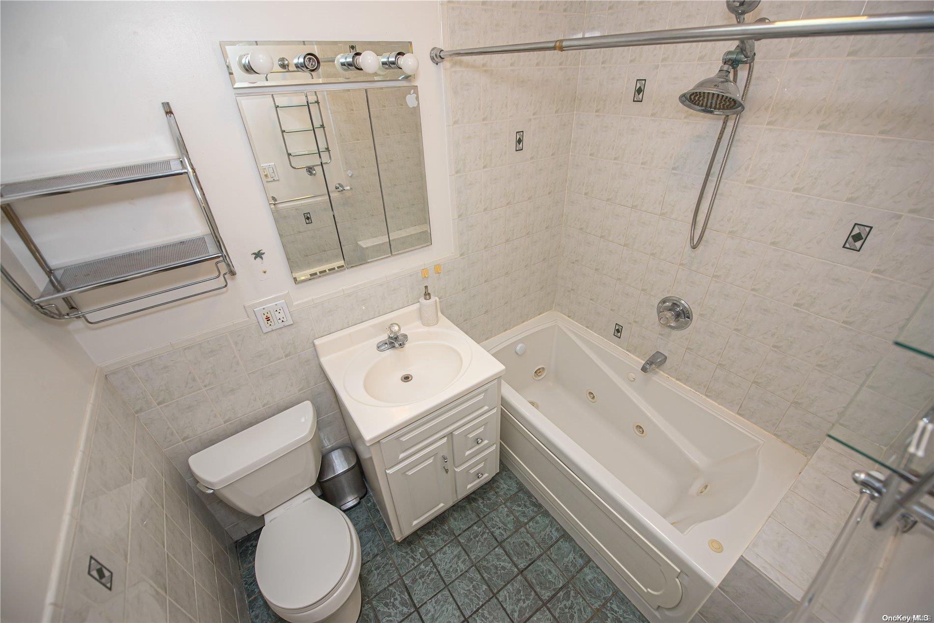 53-15 37th Road Queens, NY 11377 - Photo 13 of 25 a bathroom with a sink toilet and shower