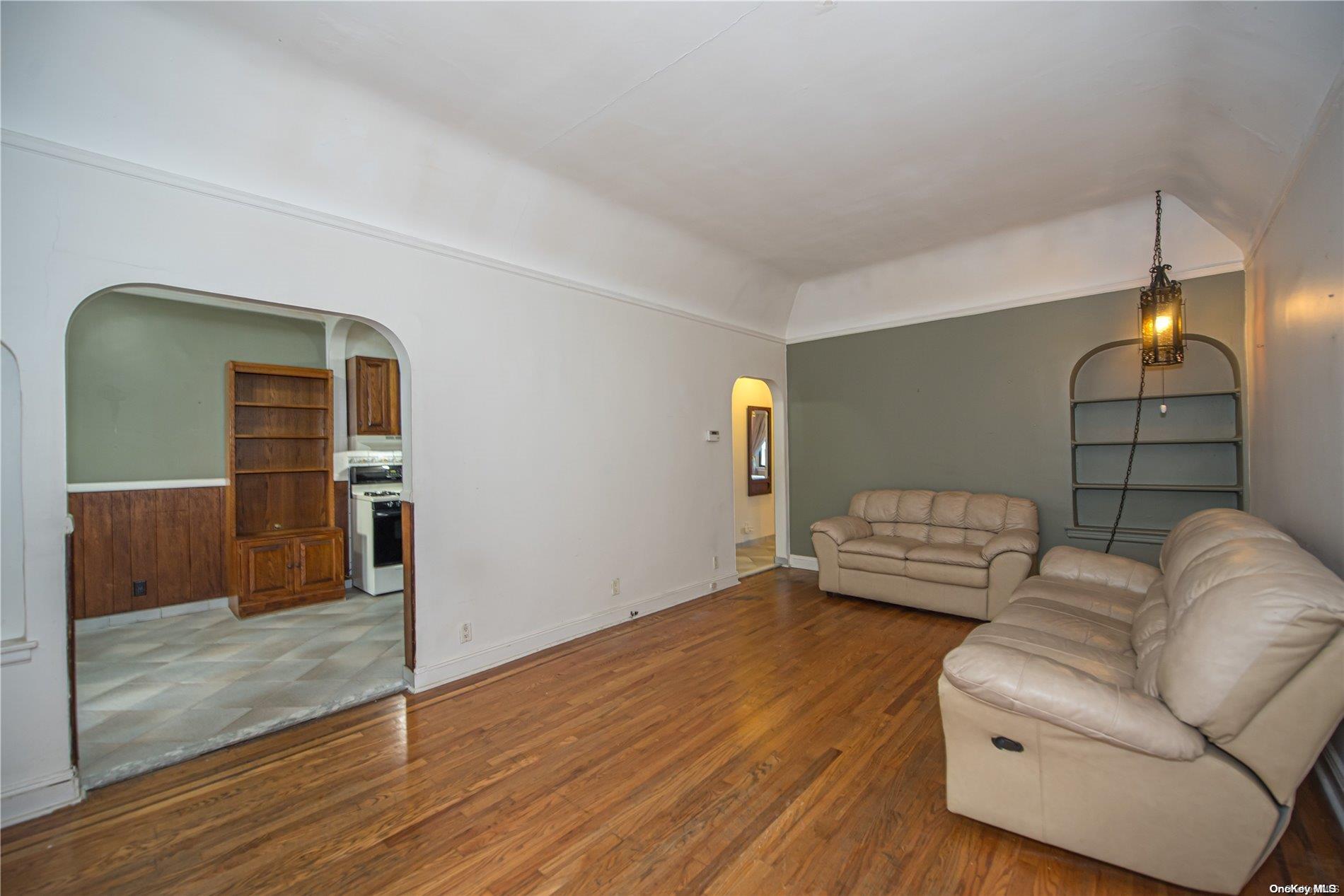 53-15 37th Road Queens, NY 11377 - Photo 2 of 25 a living room with furniture and a wooden floor