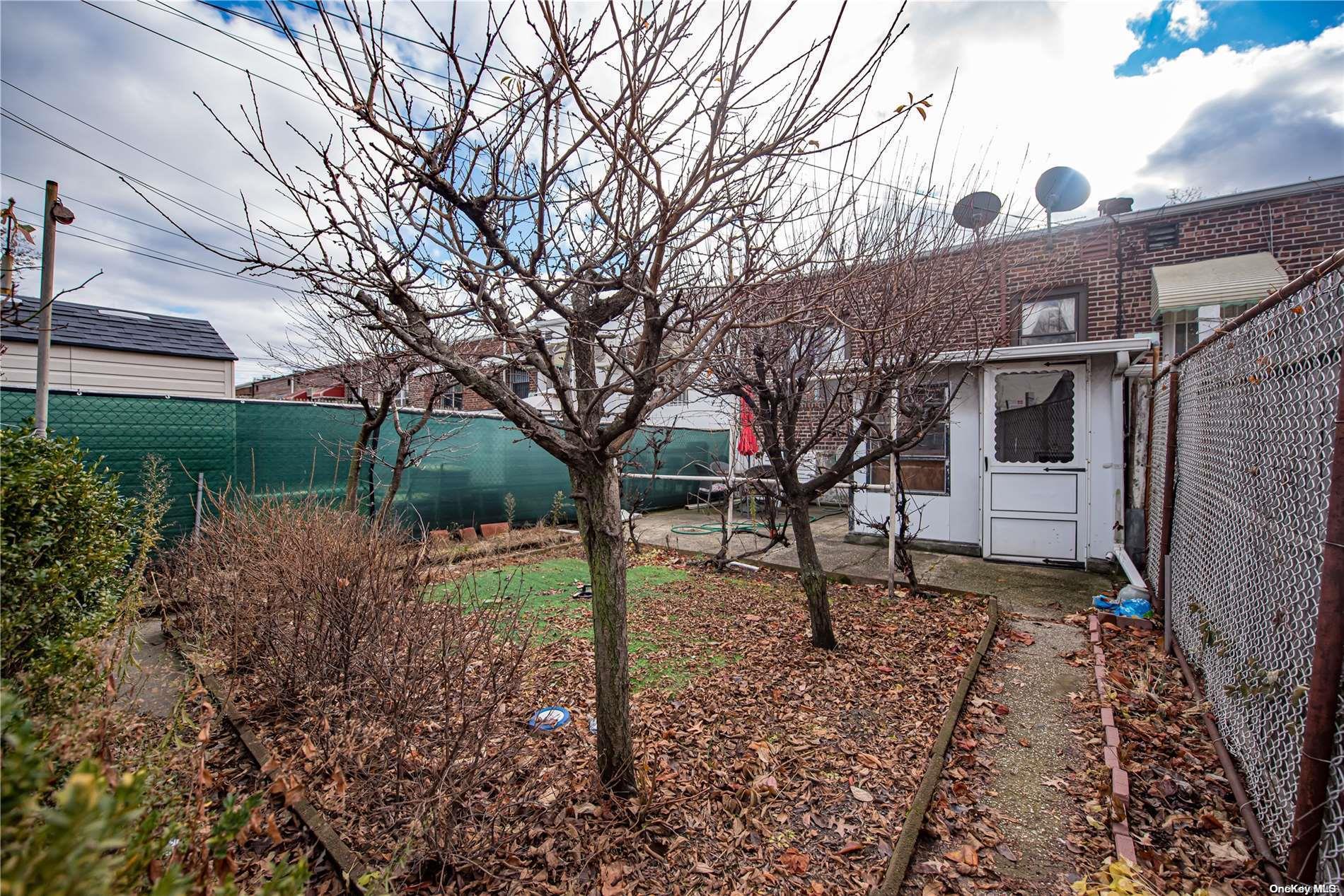 53-15 37th Road Queens, NY 11377 - Photo 23 of 25 a backyard of a house with lots of green space