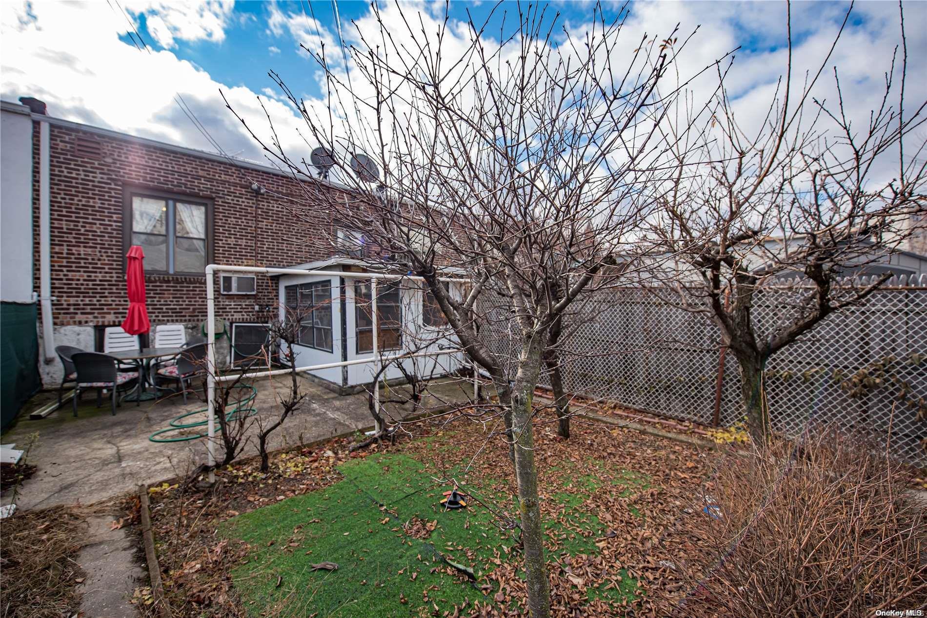 53-15 37th Road Queens, NY 11377 - Photo 24 of 25 a backyard of a house with table and chairs