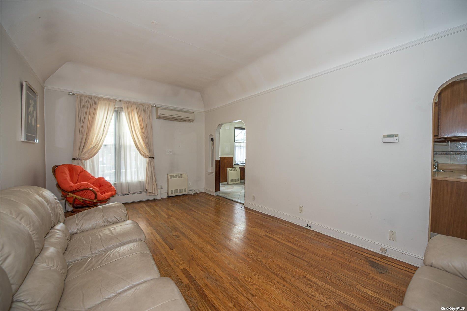 53-15 37th Road Queens, NY 11377 - Photo 3 of 25 a view of empty room with wooden floor and fan