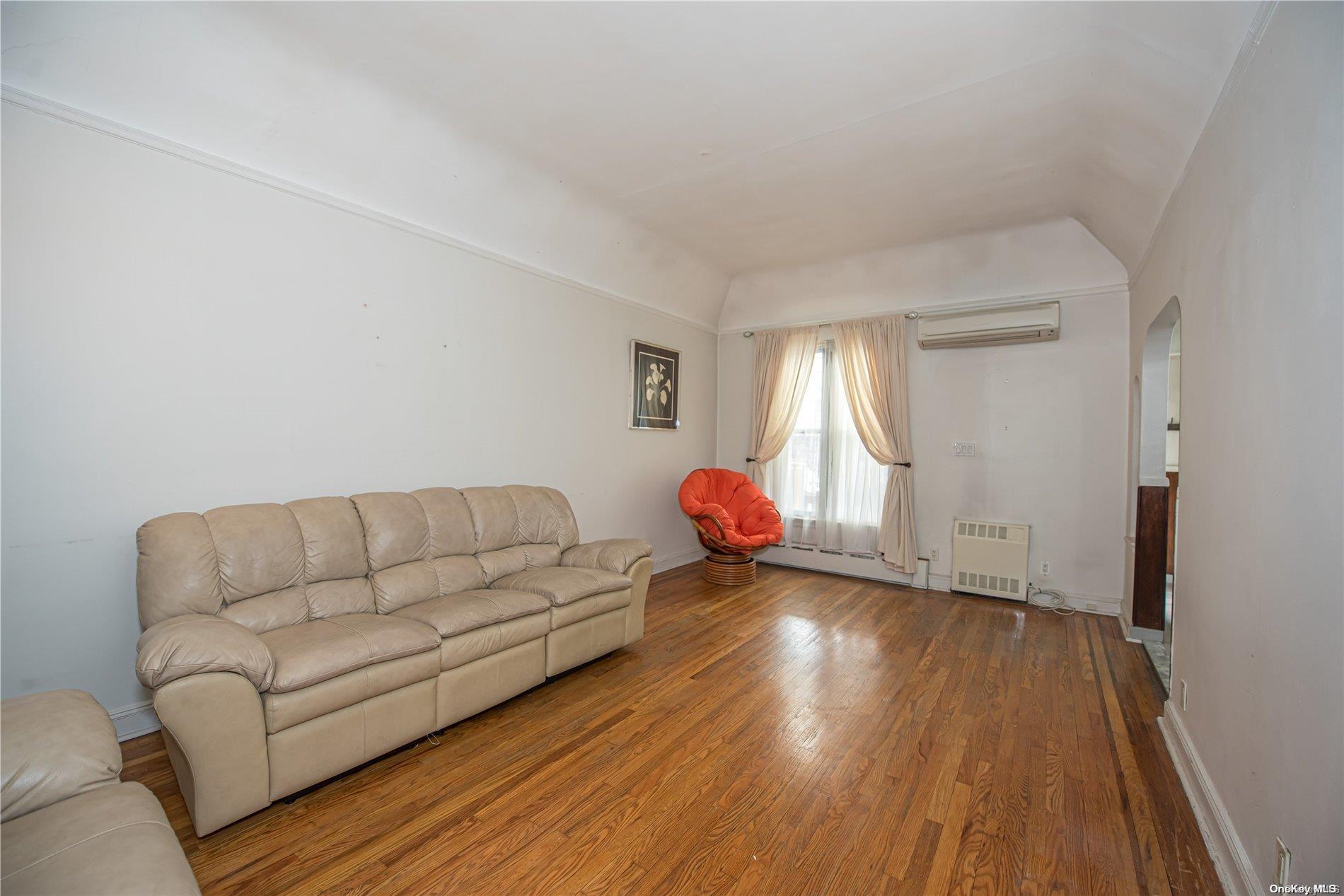 53-15 37th Road Queens, NY 11377 - Photo 4 of 25 a living room with furniture and a hard wood floor
