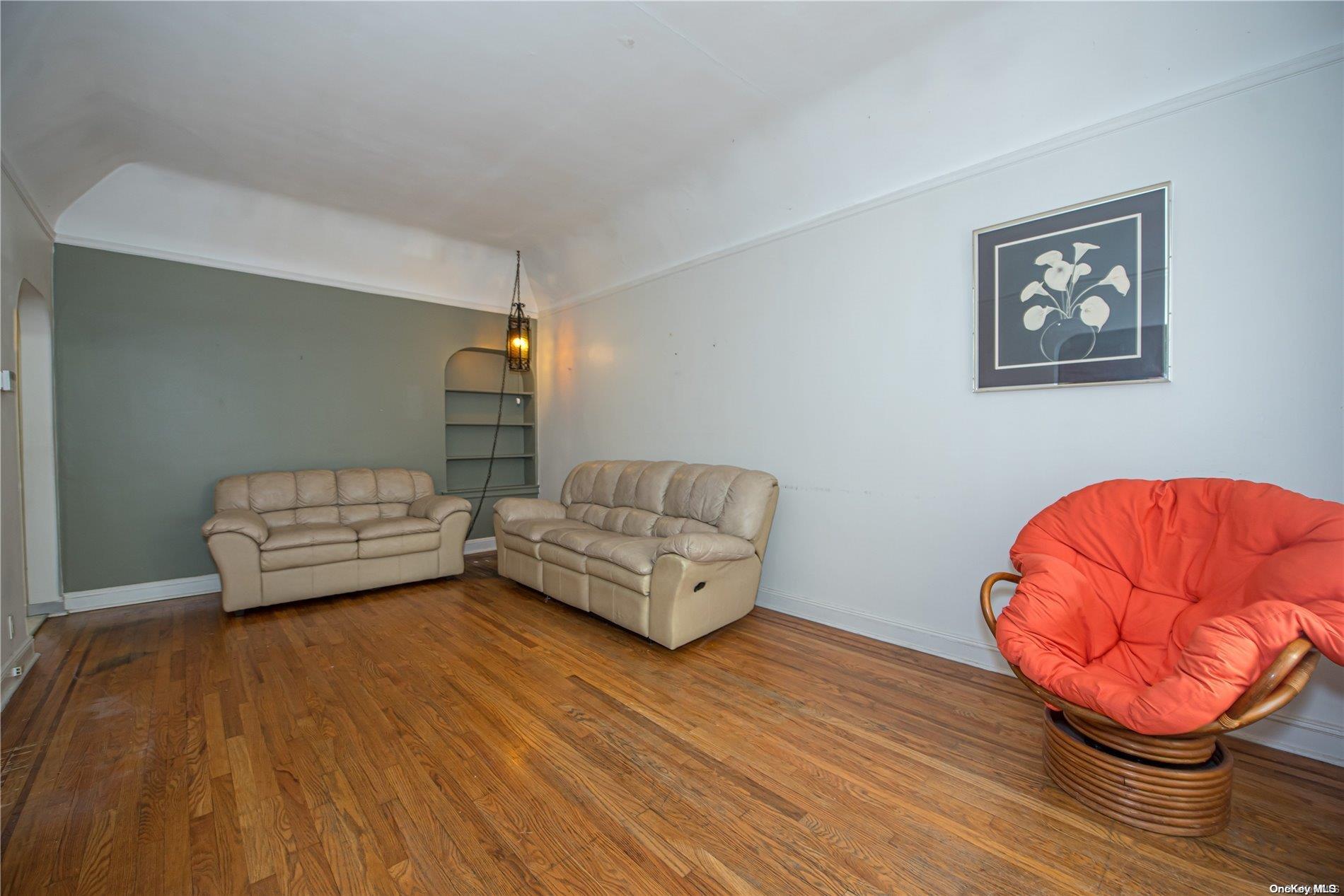 53-15 37th Road Queens, NY 11377 - Photo 5 of 25 a living room with furniture and a wooden floor
