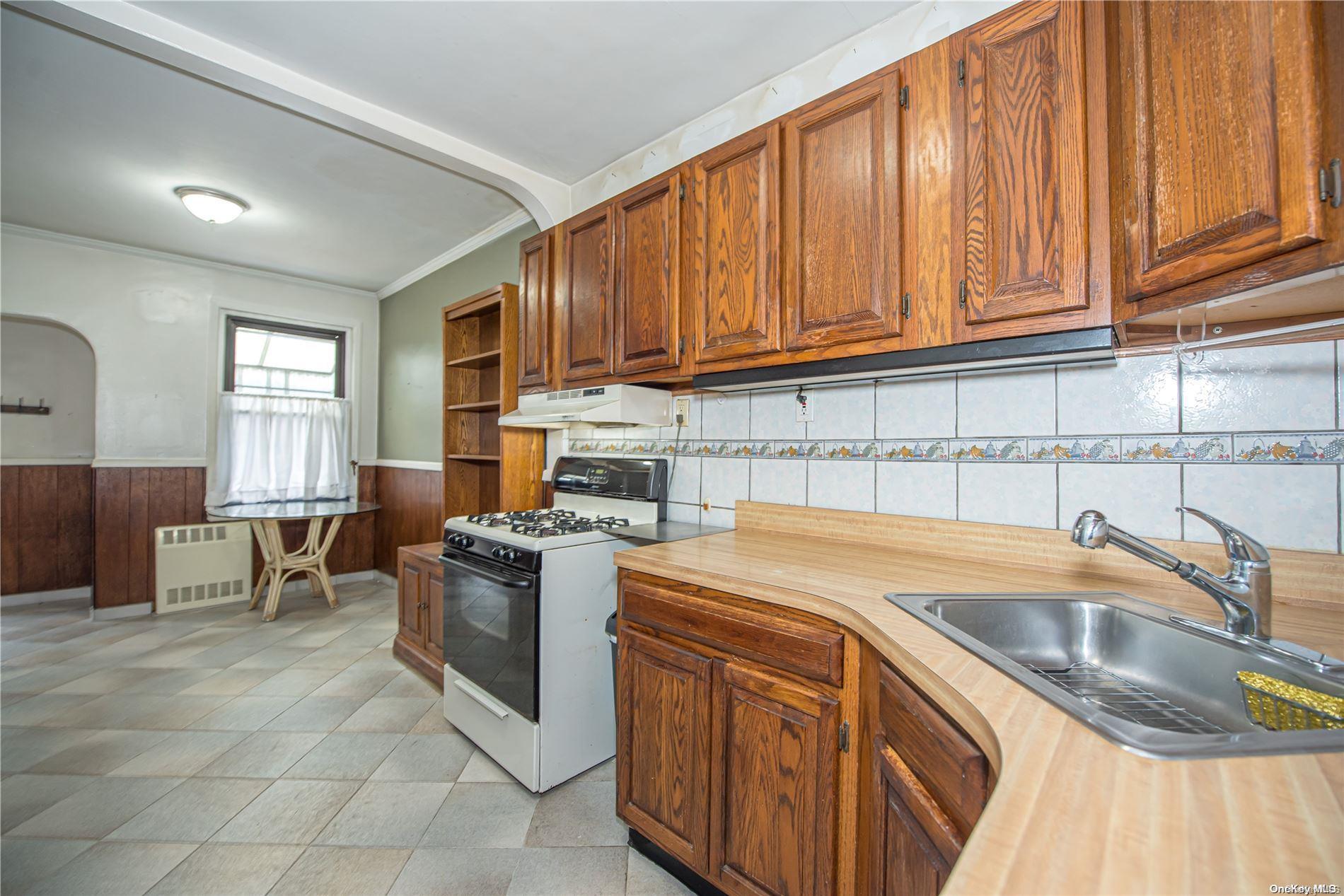 53-15 37th Road Queens, NY 11377 - Photo 9 of 25 a kitchen with stainless steel appliances granite countertop a sink stove and cabinets