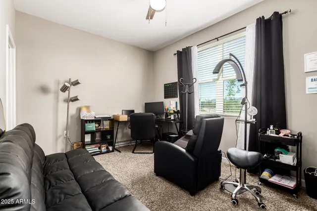 a living room with furniture a fireplace and a large window