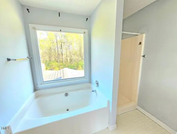 a bathroom with a tub and a sink
