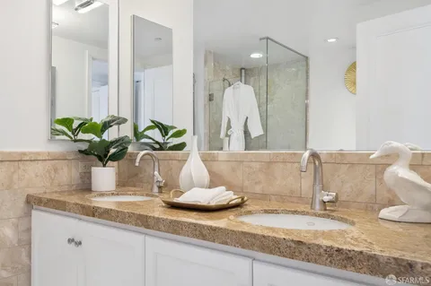 a bathroom with a granite countertop sink and a mirror