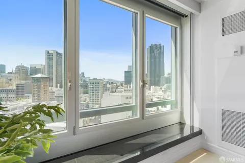 a living room with furniture and outdoor view