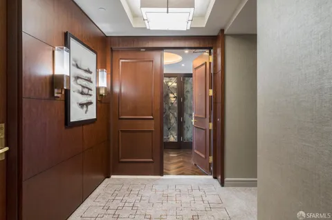 a view of hallway with wooden floor and stairs