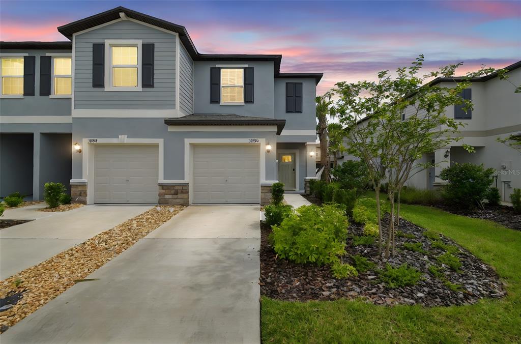 36390 Wl Hl Way Zephyrhills, FL 33541 - Photo 1 of 77 a front view of a house with a yard and garage
