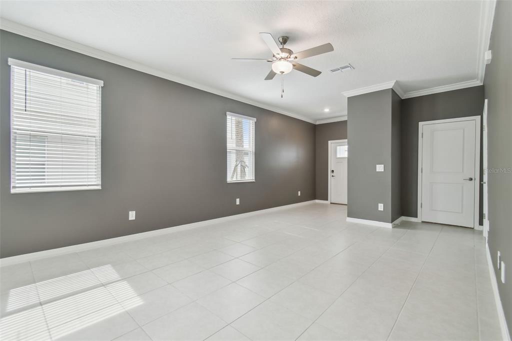 36390 Wl Hl Way Zephyrhills, FL 33541 - Photo 12 of 77 a view of an empty room with chandelier fan and a window