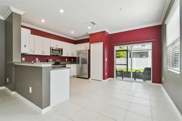 a kitchen with stainless steel appliances granite countertop a refrigerator sink and stove