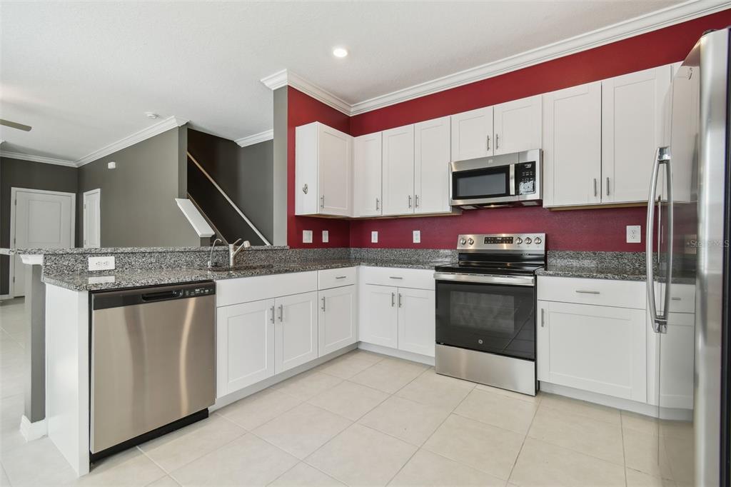 36390 Wl Hl Way Zephyrhills, FL 33541 - Photo 18 of 77 a kitchen with stainless steel appliances granite countertop a sink and cabinets
