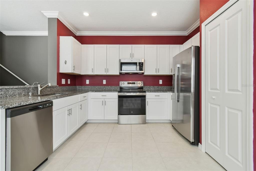 36390 Wl Hl Way Zephyrhills, FL 33541 - Photo 19 of 77 a kitchen with stainless steel appliances granite countertop a refrigerator sink and stove