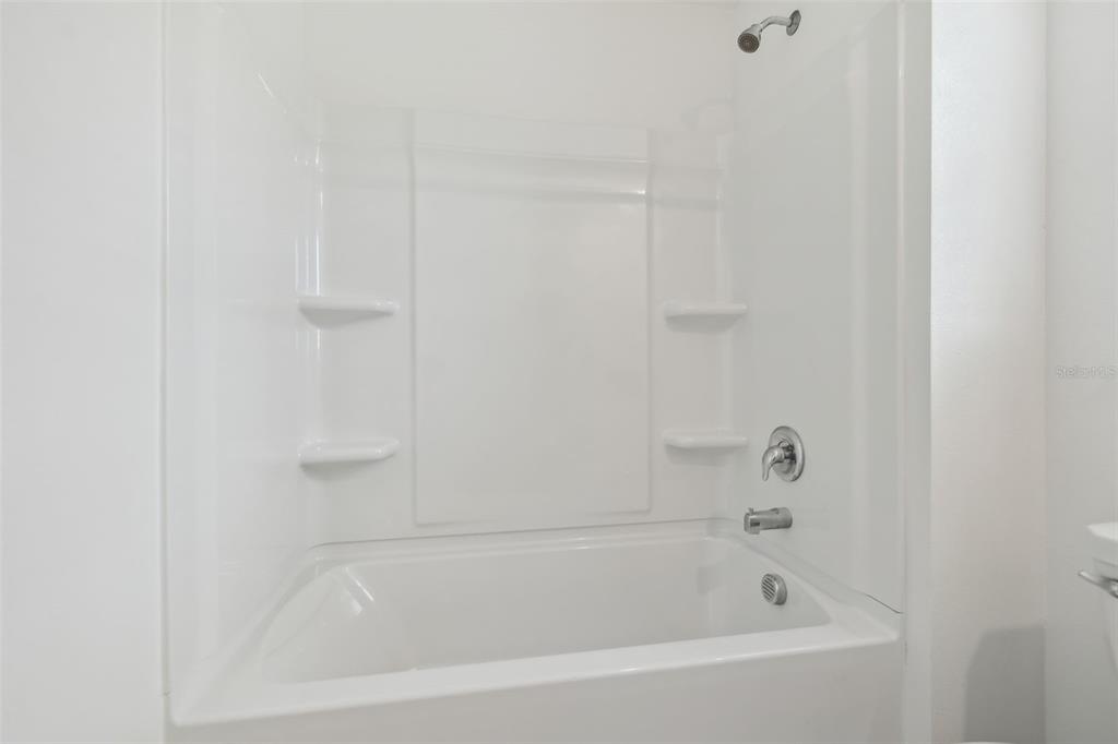 36390 Wl Hl Way Zephyrhills, FL 33541 - Photo 32 of 77 a close up of a bathtub curtain