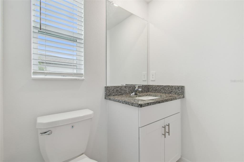 36390 Wl Hl Way Zephyrhills, FL 33541 - Photo 33 of 77 a bathroom with a granite countertop sink and a toilet