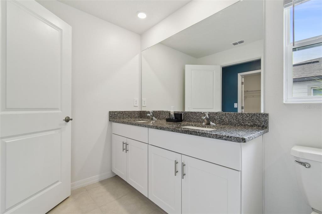 36390 Wl Hl Way Zephyrhills, FL 33541 - Photo 36 of 77 a bathroom with a granite countertop sink and a mirror