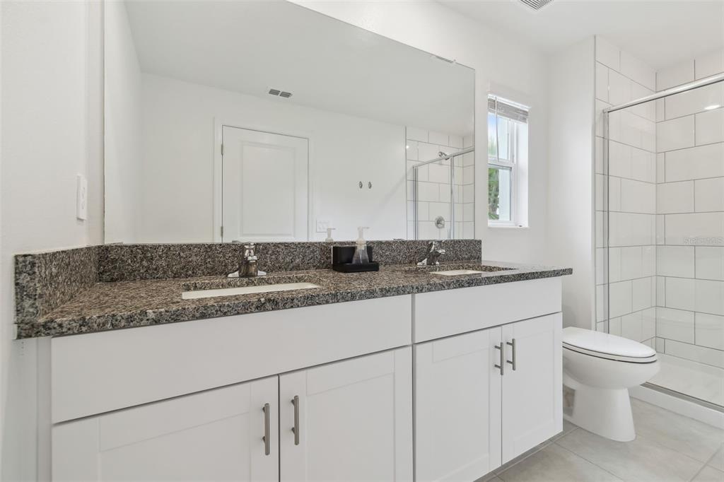 36390 Wl Hl Way Zephyrhills, FL 33541 - Photo 37 of 77 a bathroom with a granite countertop sink and a toilet