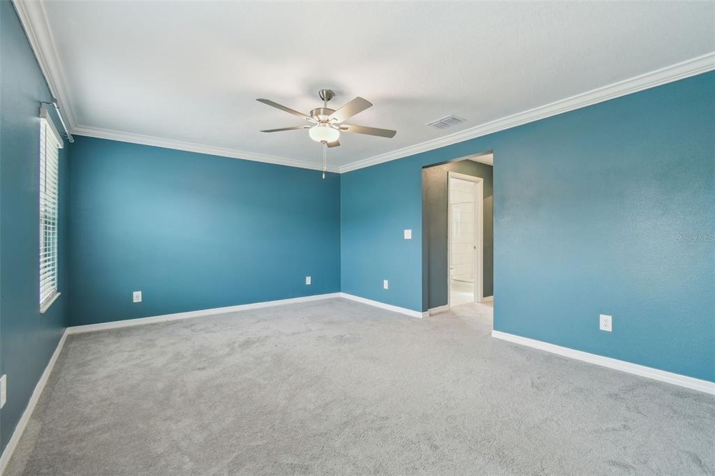 36390 Wl Hl Way Zephyrhills, FL 33541 - Photo 42 of 77 a view of an empty room with a ceiling fan