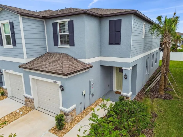 an aerial view of residential houses with outdoor space