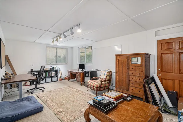 a living room with furniture a piano and wooden floor
