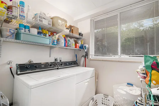 a utility room with dryer washer and a window