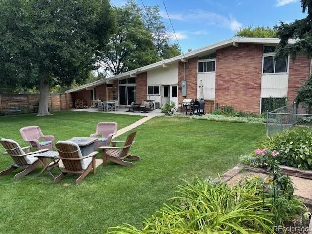 a backyard of a house with table and chairs