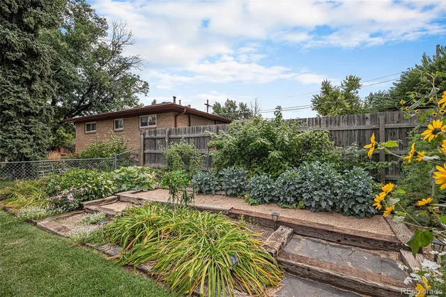 a view of a garden with a house