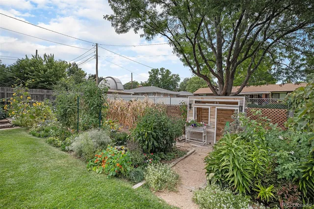 a view of a house with a yard and potted plants