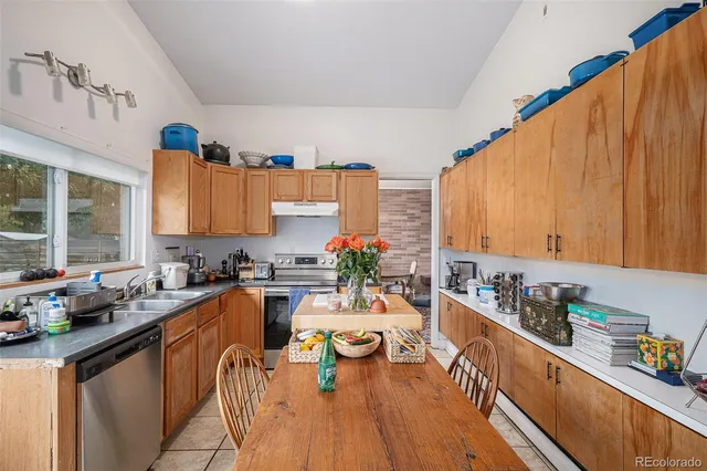 a kitchen with lots of counter top space a sink and appliances